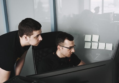 Employees reviewing work on a screen
